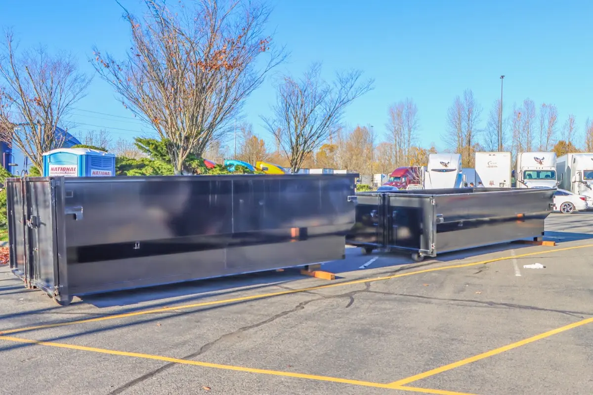 Professional dumpster rental service with roll-off container on residential driveway in Angola